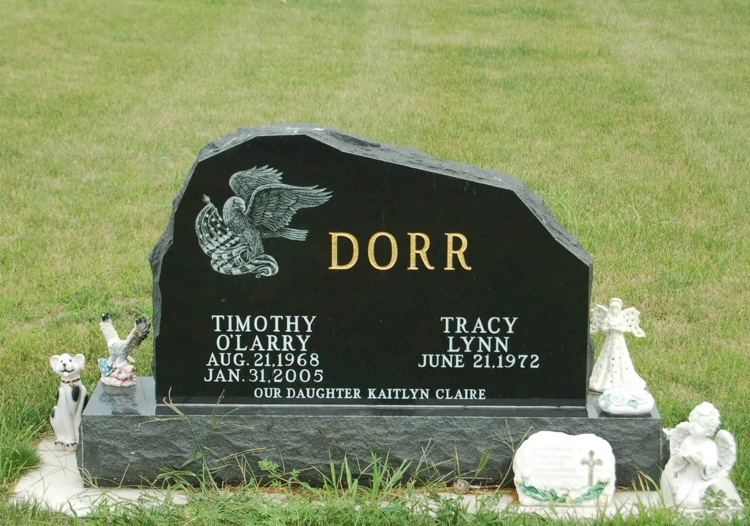 Black Dorr family gravestone with eagle etching in a grassy cemetery