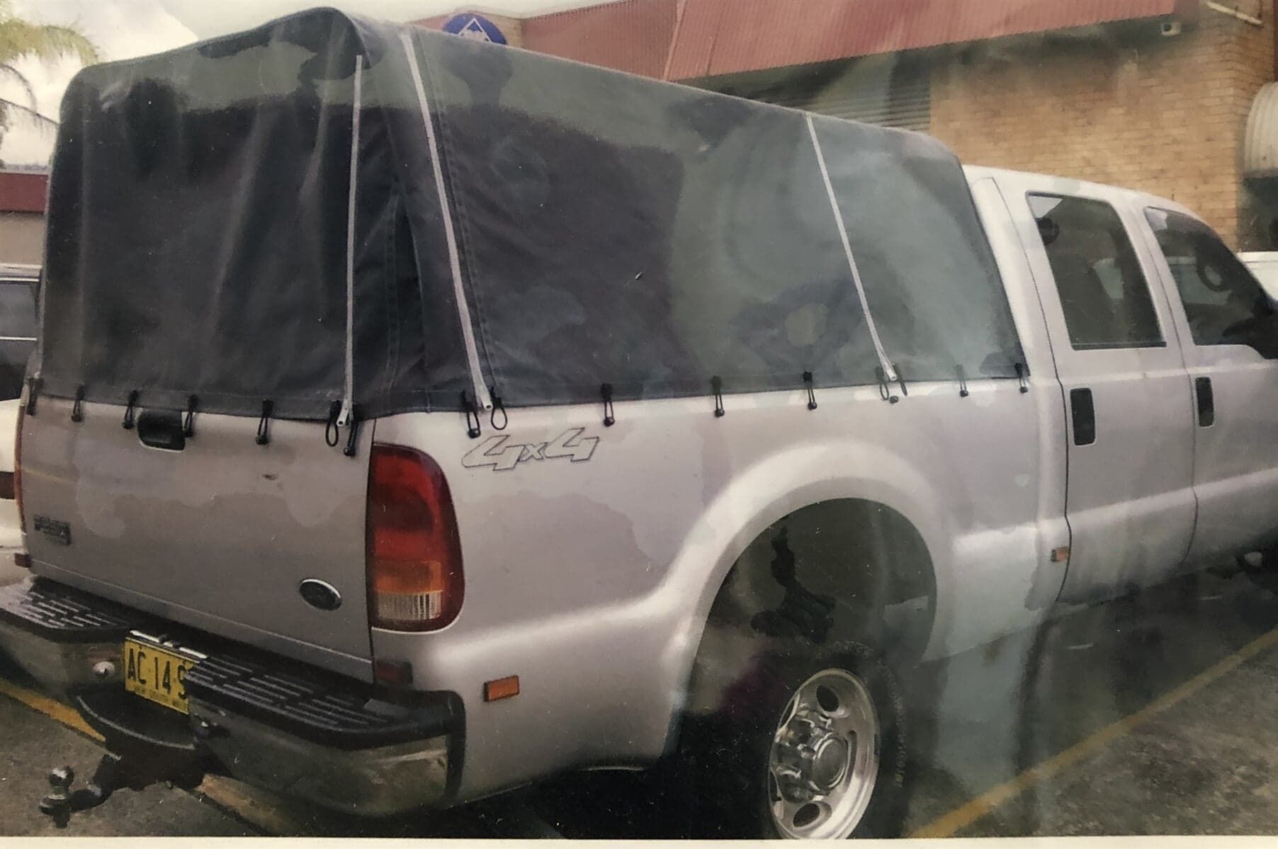 A Silver Truck with A Canopy on The Back Is Parked in A Parking Lot - Quality Canvas Products In Illawarra, NSW
