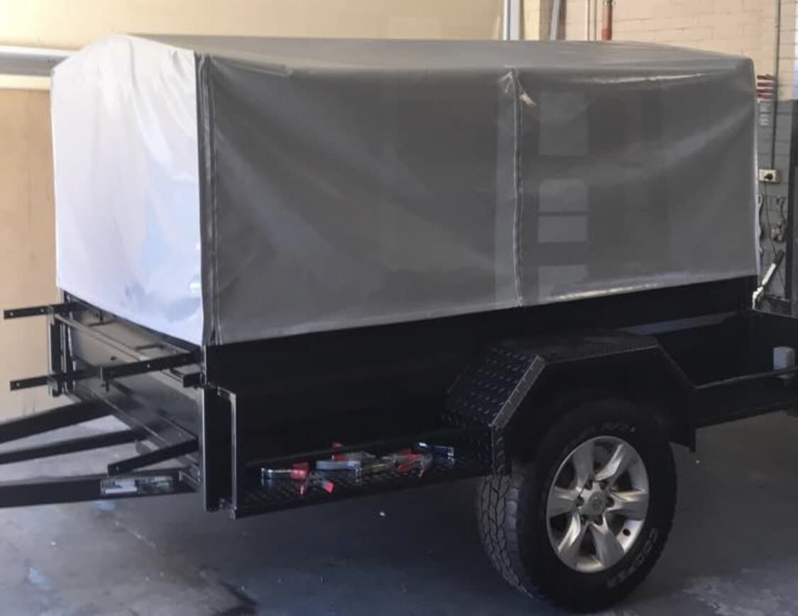 A Black Trailer with A White Tarp on Top Is Parked in A Garage - Quality Canvas Products In Illawarra, NSW