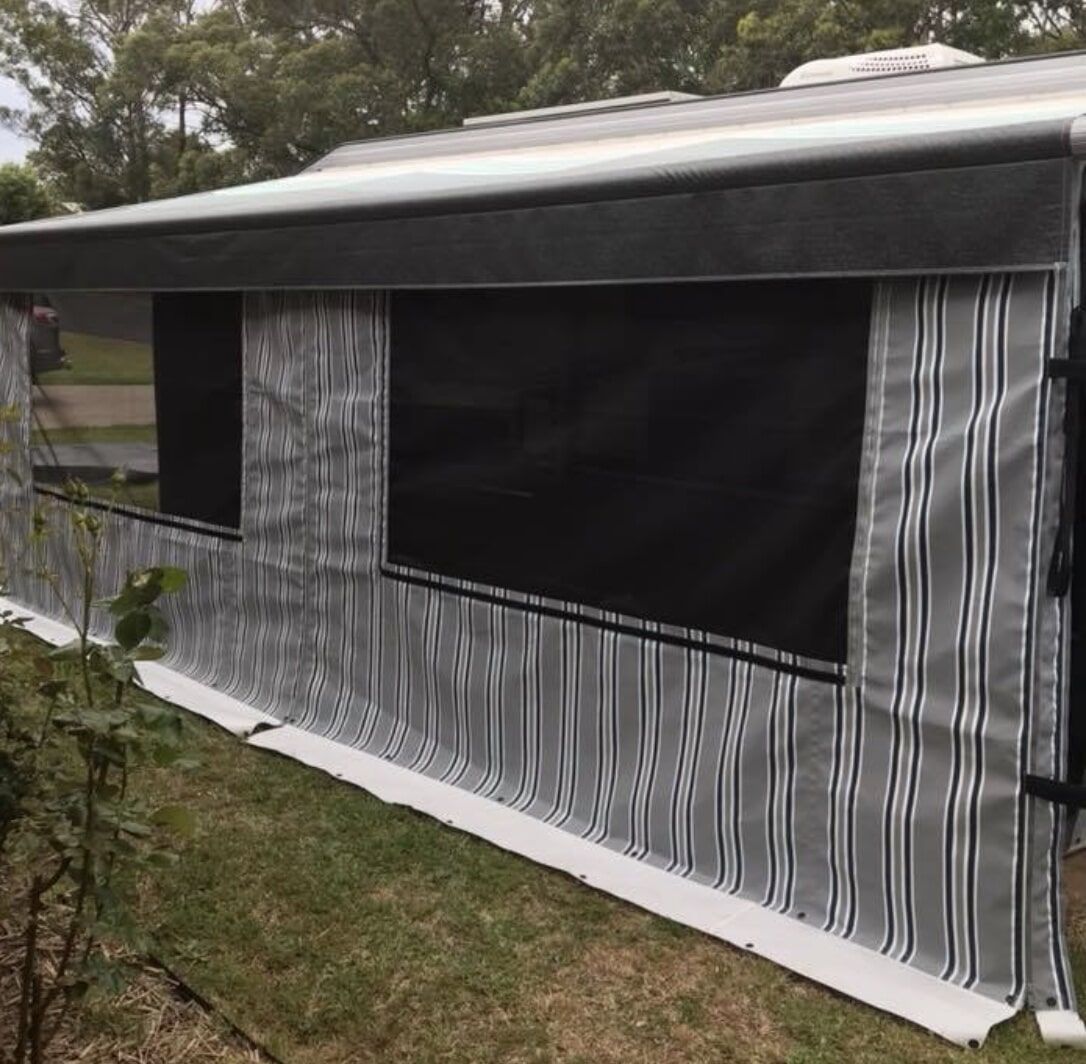 A Caravan with A Striped Awning on The Side of It - Quality Canvas Products In Illawarra, NSW