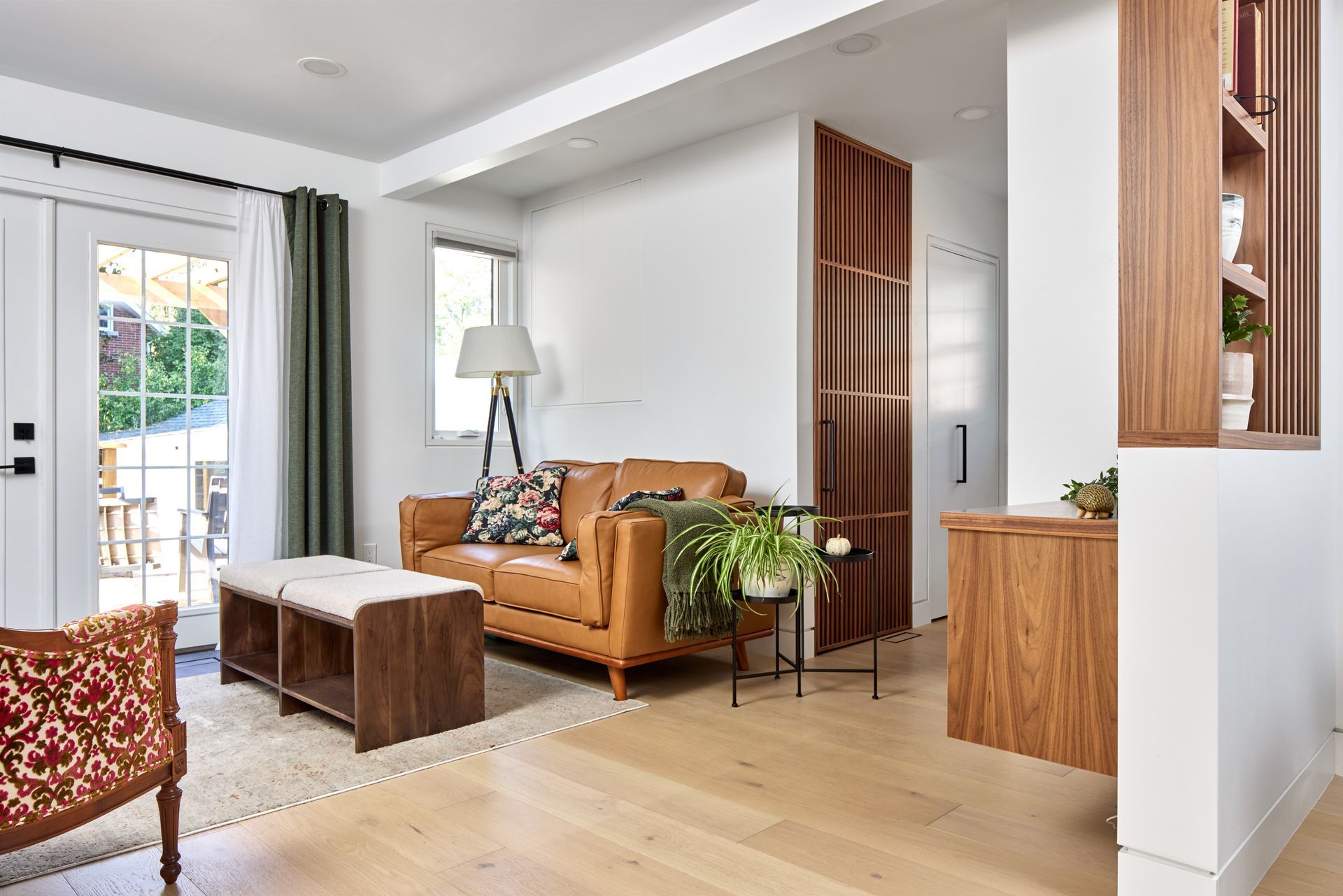 A living room with a brown leather couch and a wooden coffee table.