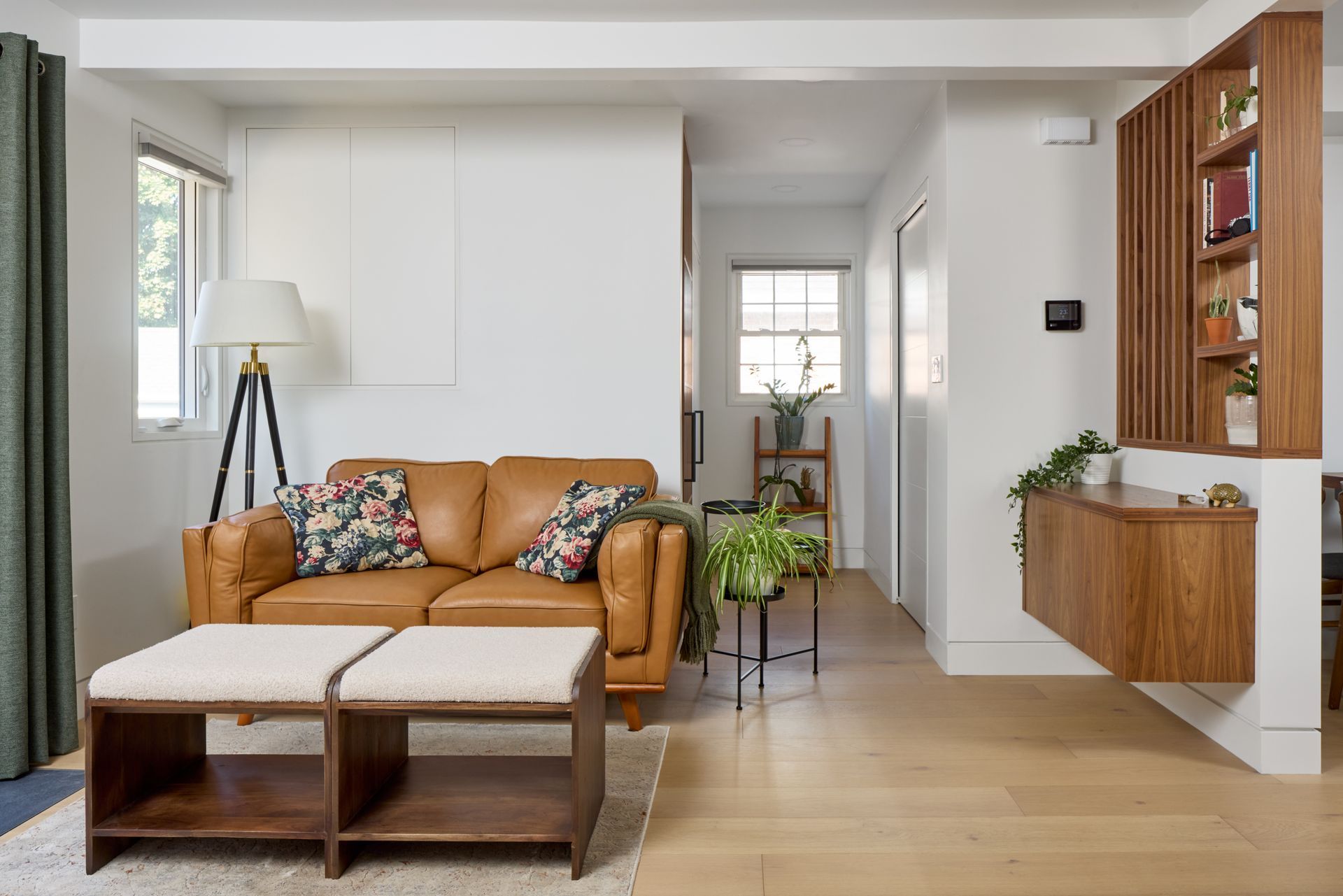 A living room with a brown couch and a coffee table.