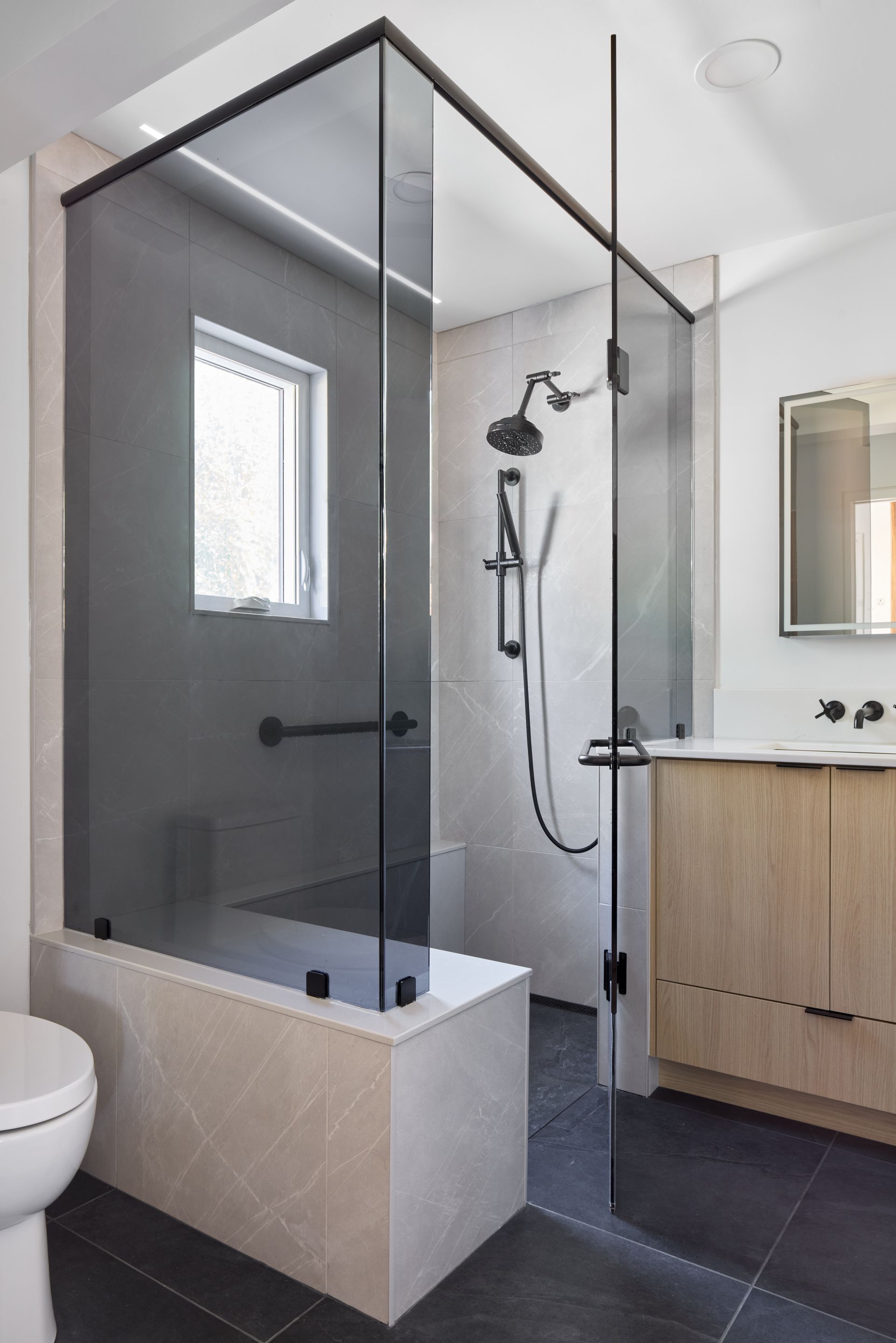 A bathroom with a walk in shower and a bathtub.