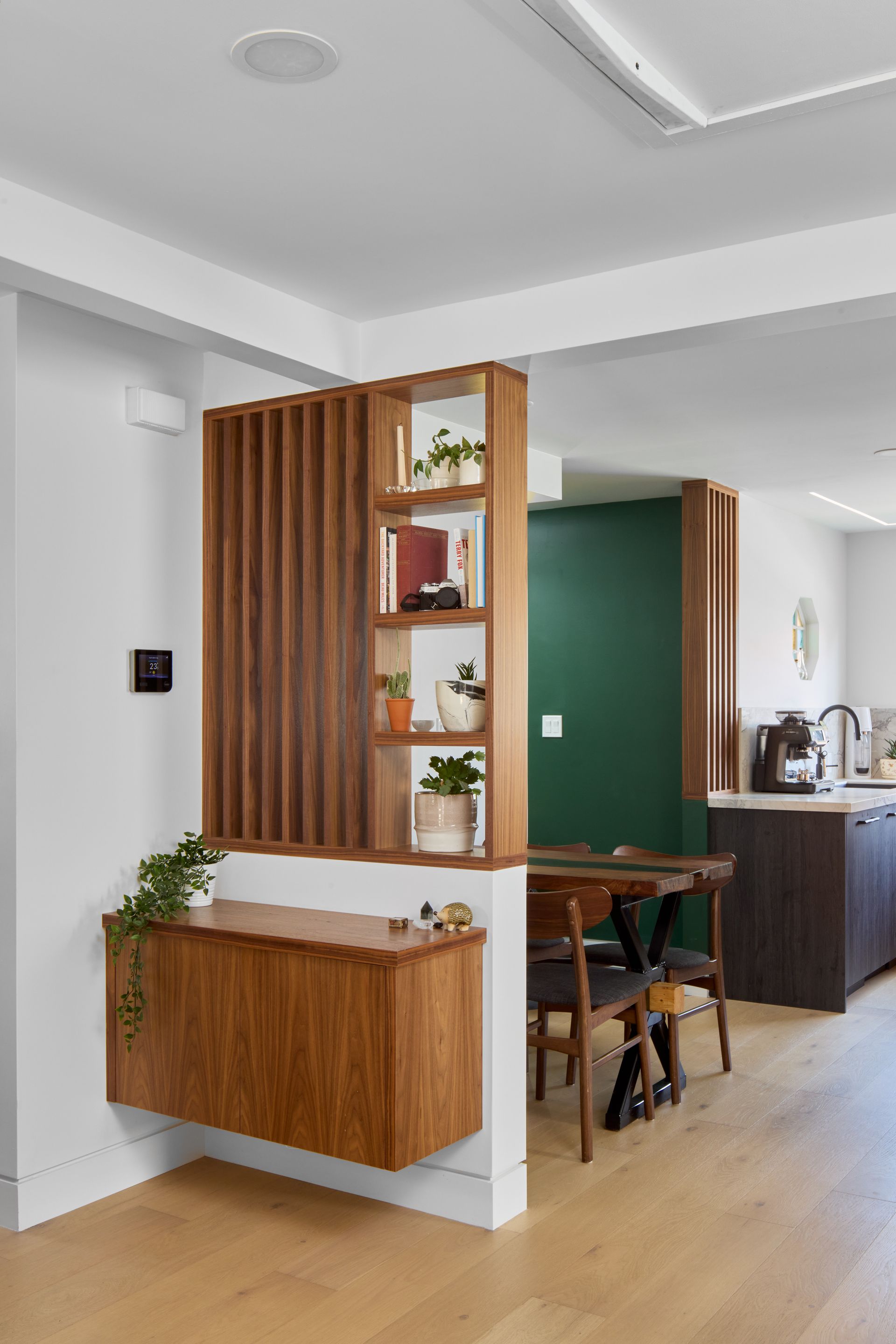 A room with a wooden divider between the kitchen and dining room.