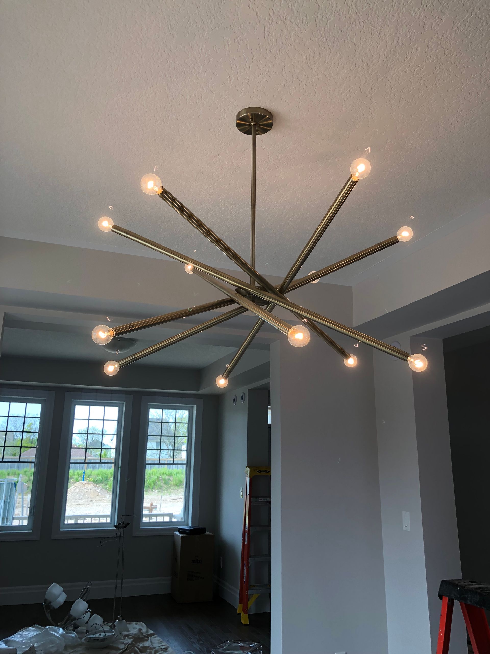 A chandelier is hanging from the ceiling in a living room