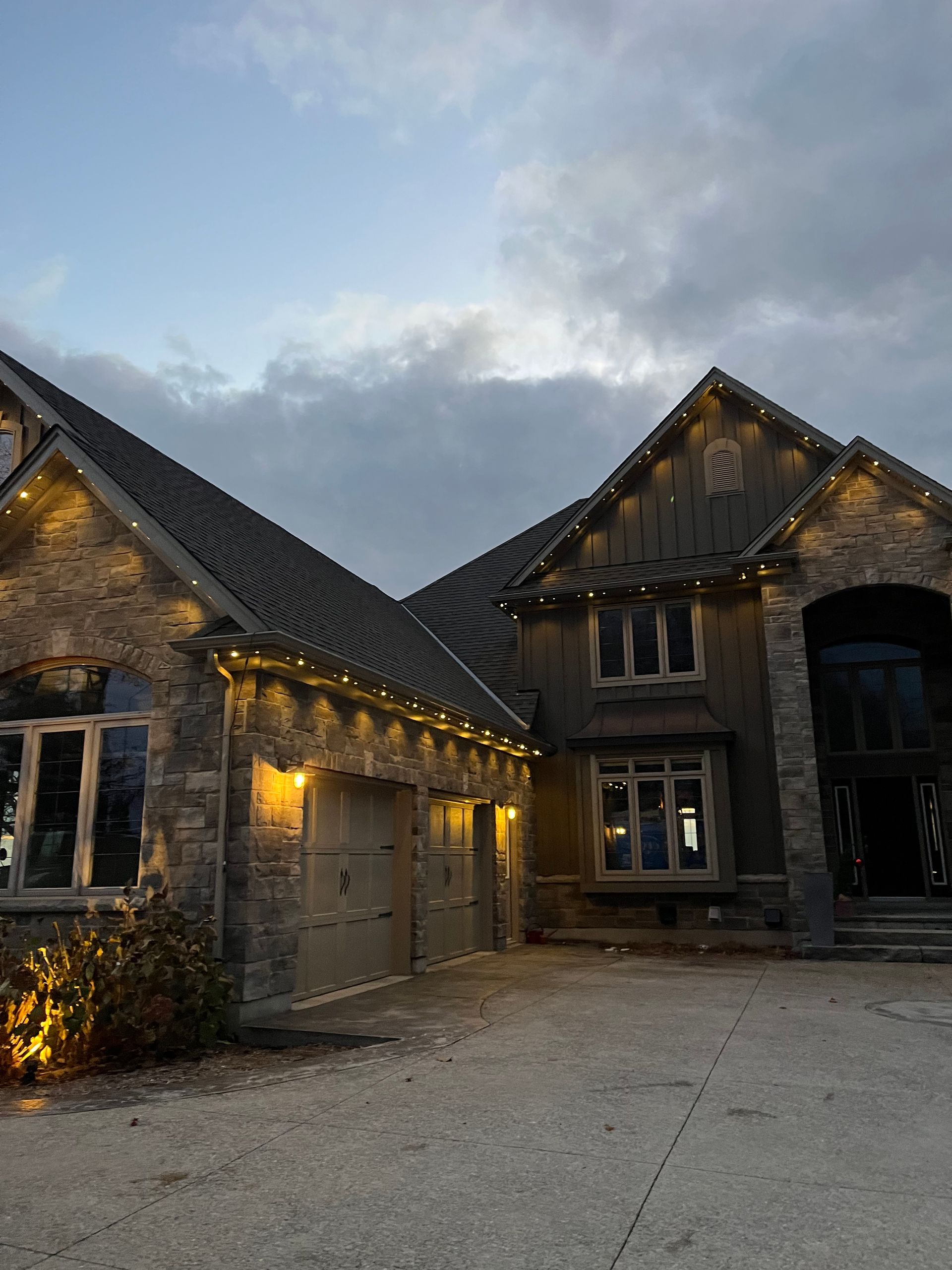 A large house with christmas lights on the roof