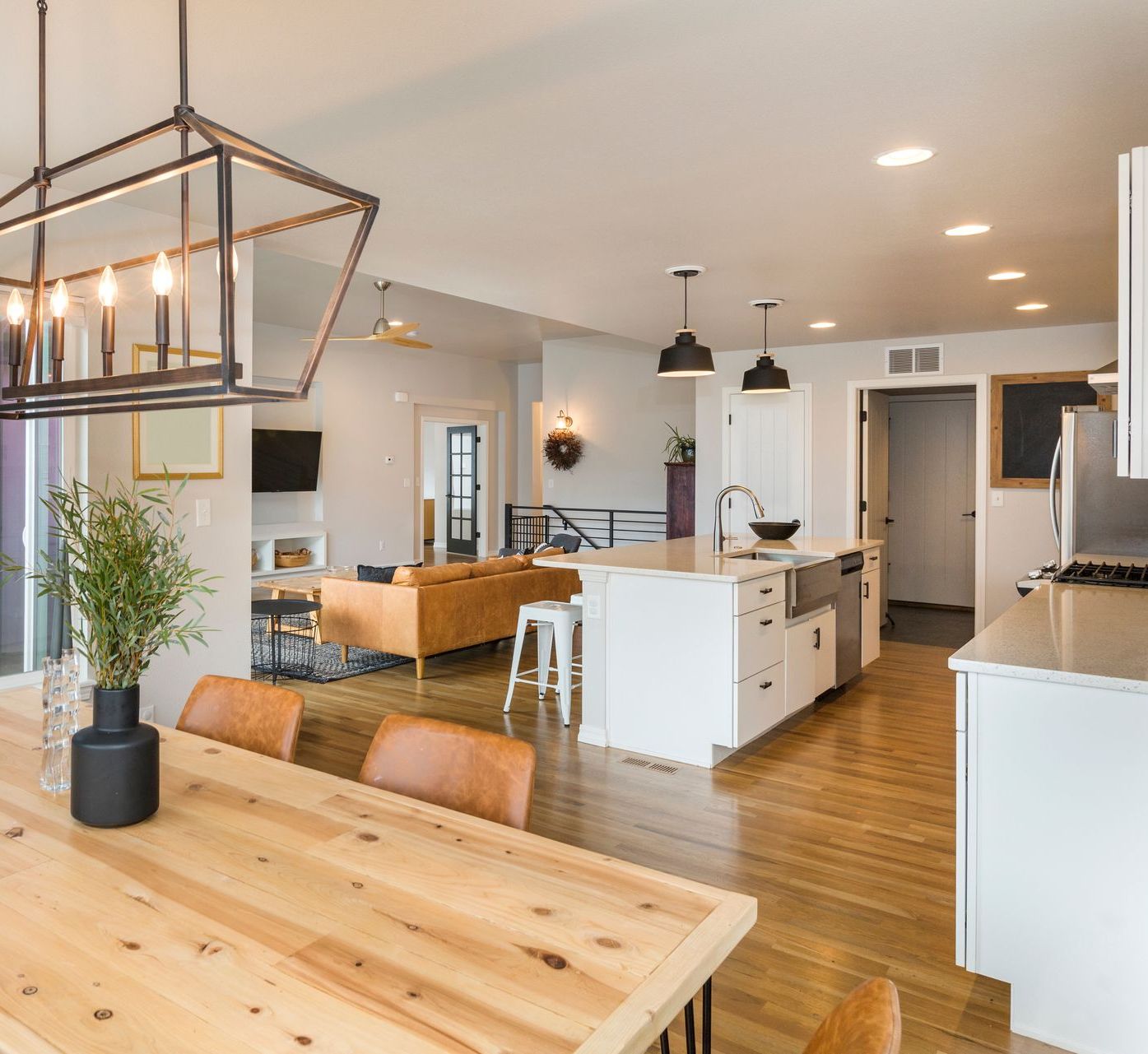 A kitchen with a wooden table and chairs in it