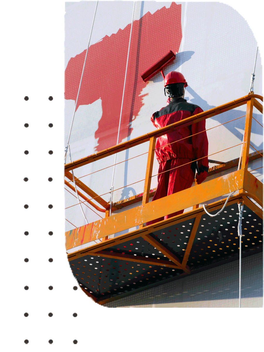 A man with a red overall painting a wall | Sydney, NSW | Polypaint A man with a red overall painting a wall | Sydney, NSW | Polypaint