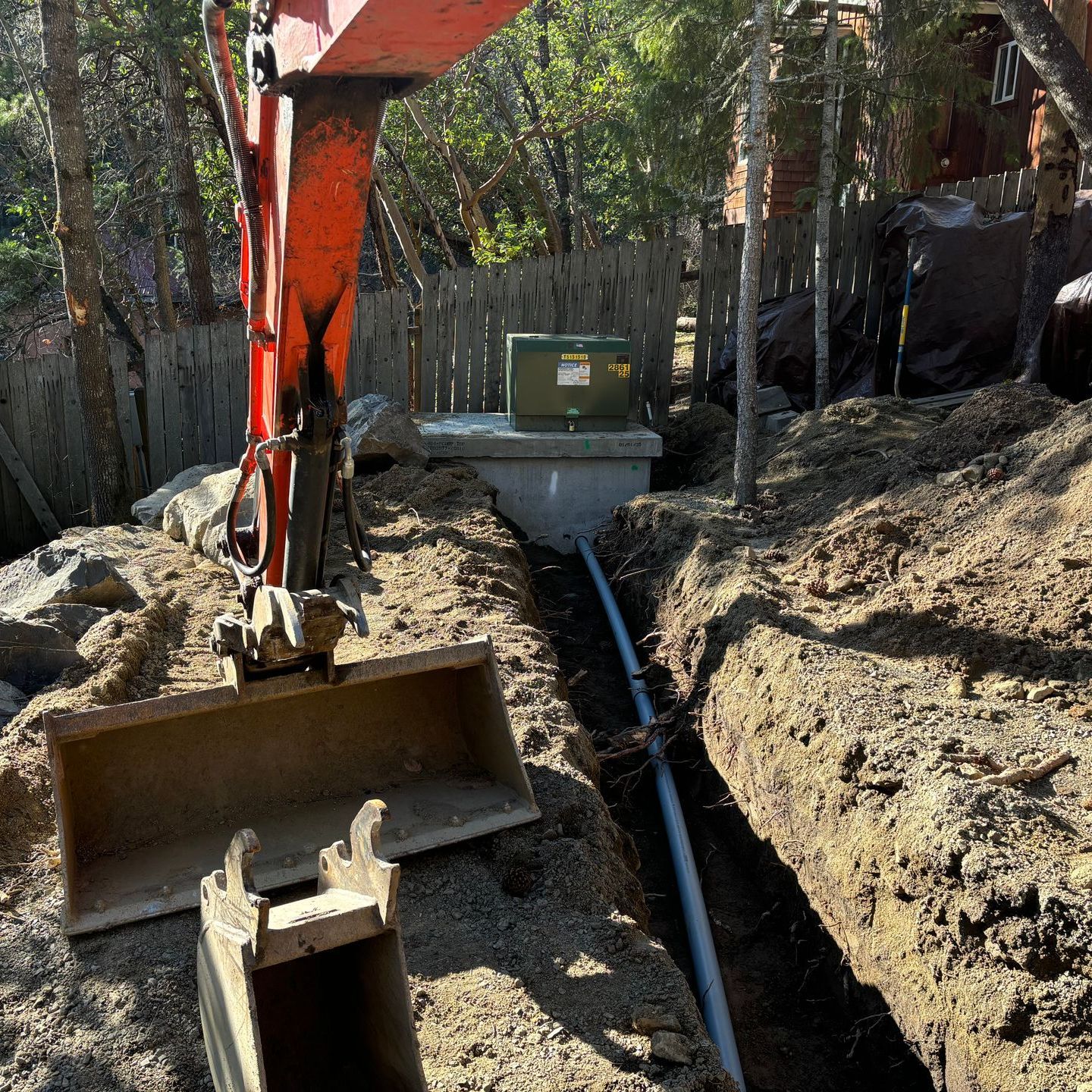 An excavator is digging a trench for electricity in Ashland, Oregon