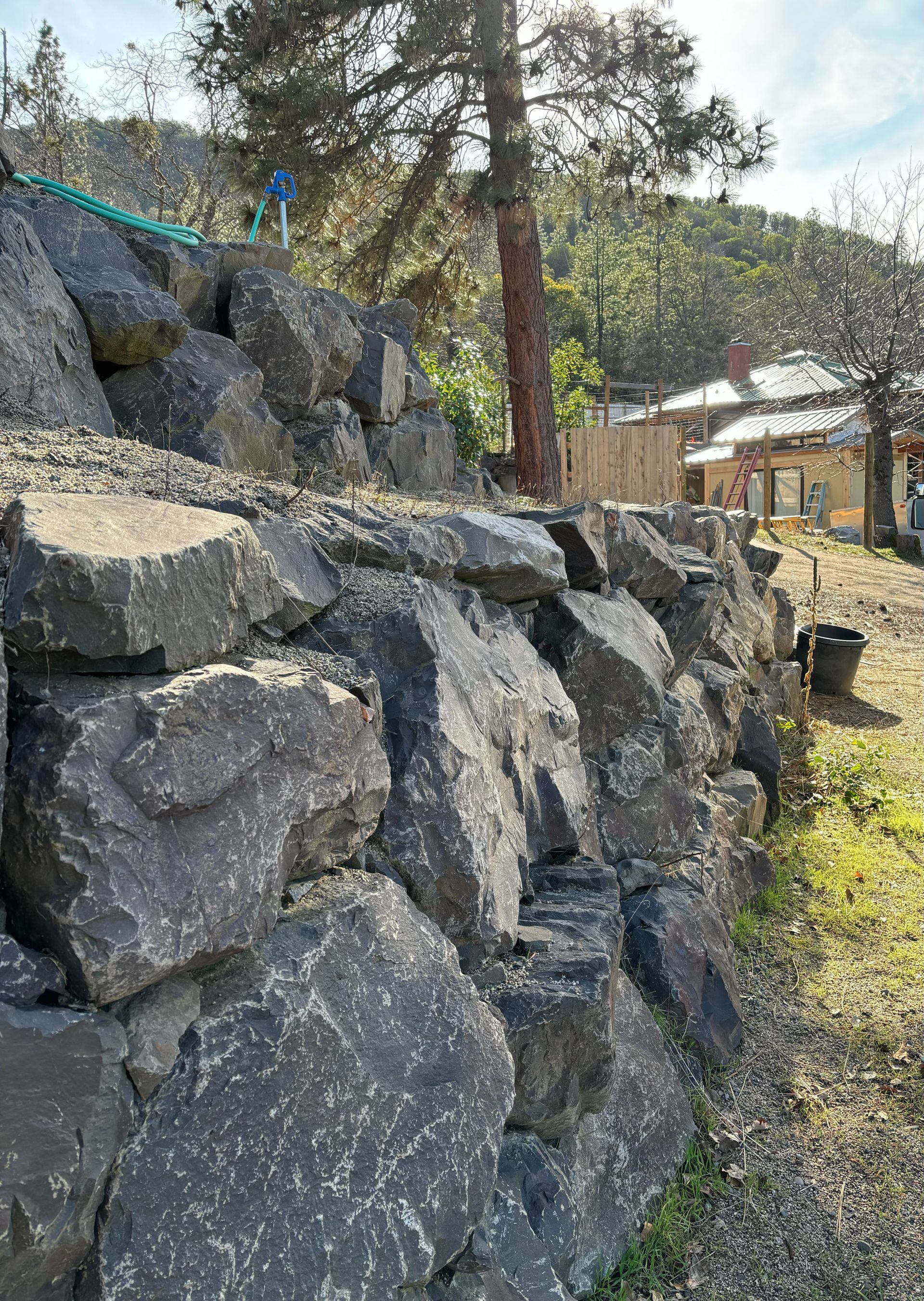 A rock wall in front of a house in Ashland, Oregon