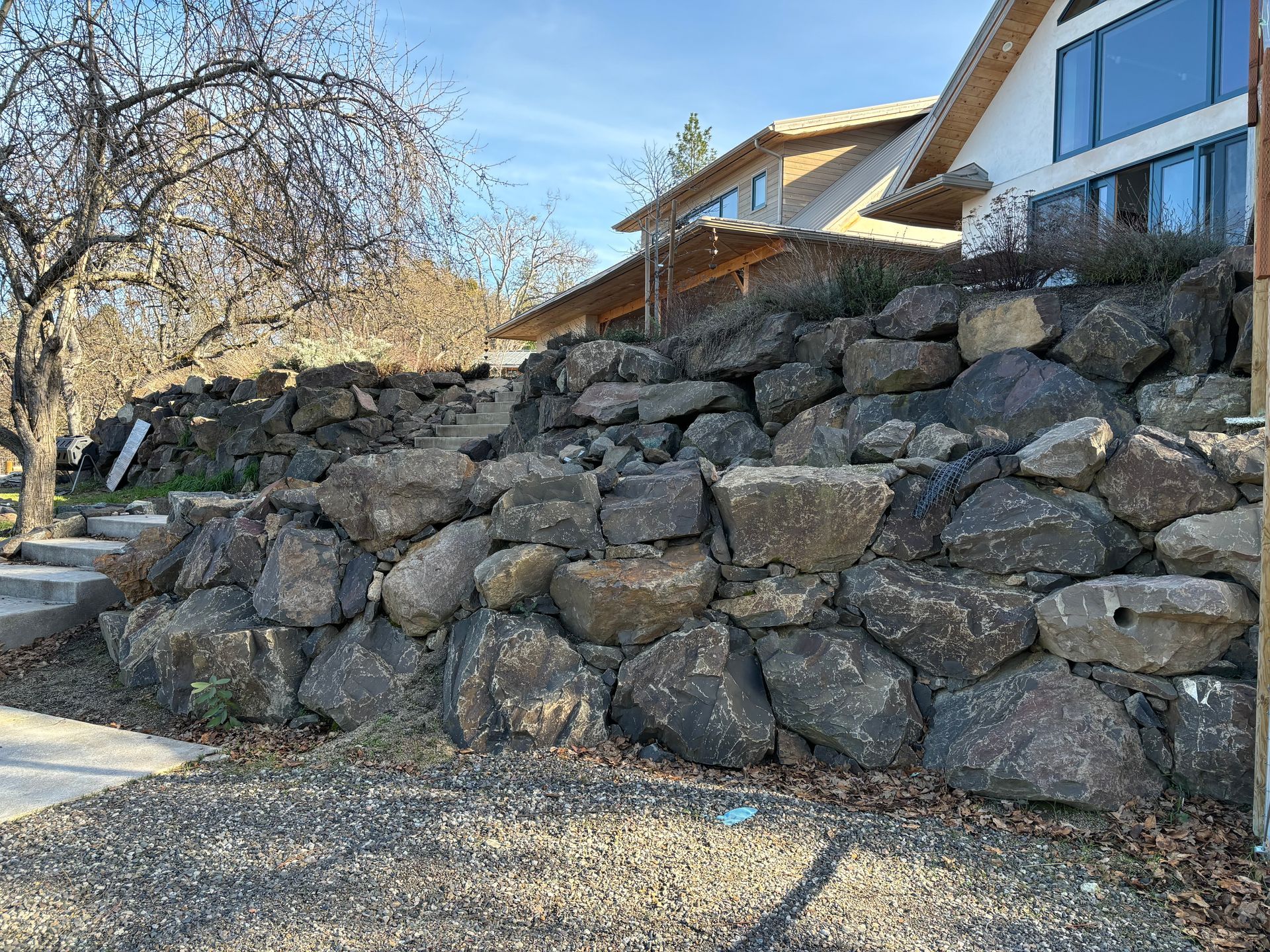 A rock wall in front of a house in Ashland, Oregon