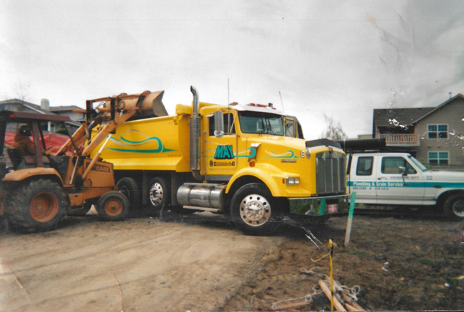 A yellow dump truck getting loaded with decomposed granite in the May Rock Granite pit in Ashland, Oregon.