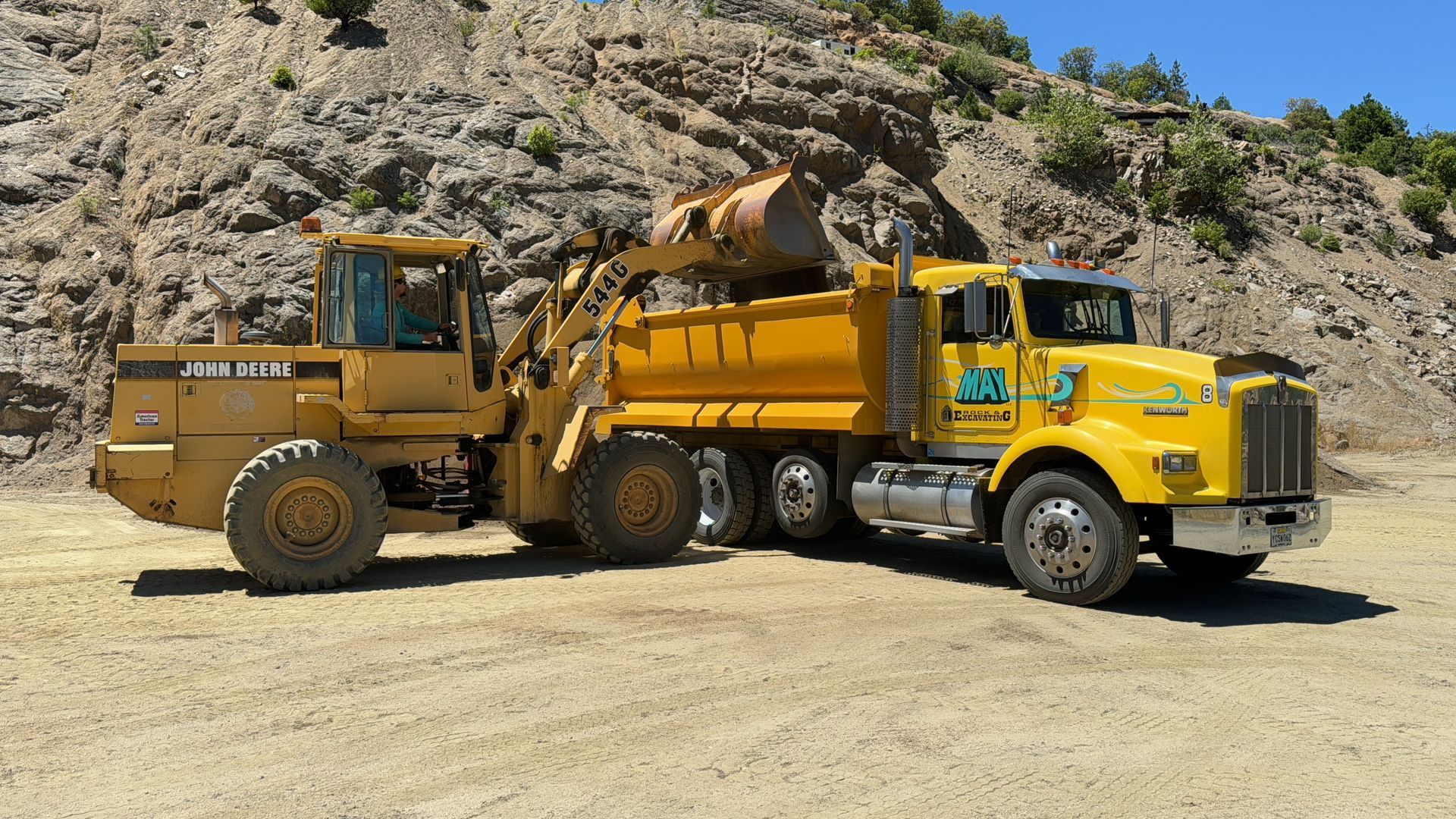 A dump truck is getting loaded with decomposed granite for a driveway in Ashland, Oregon.