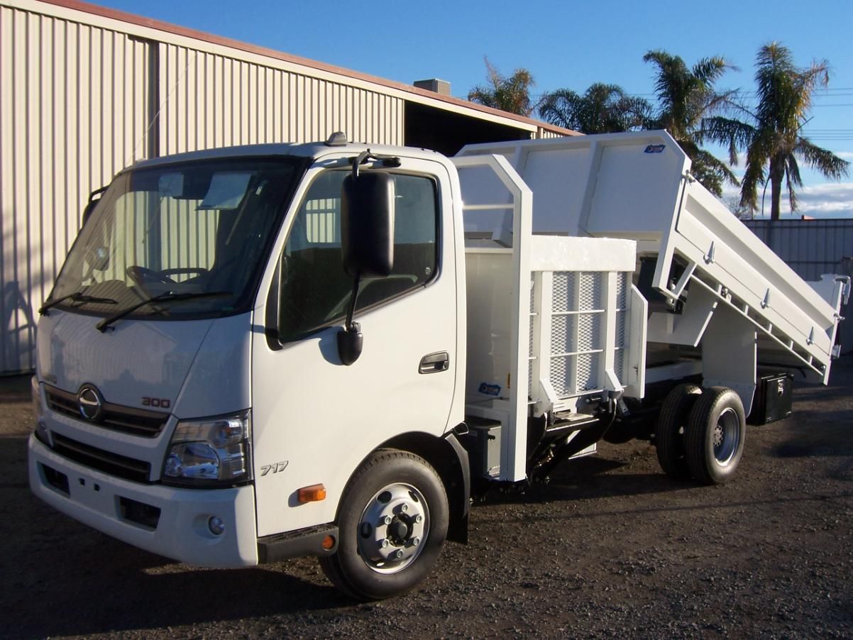A White Dump Truck Is Parked In Front Of A Building — TMF Engineering In Shepparton, VIC