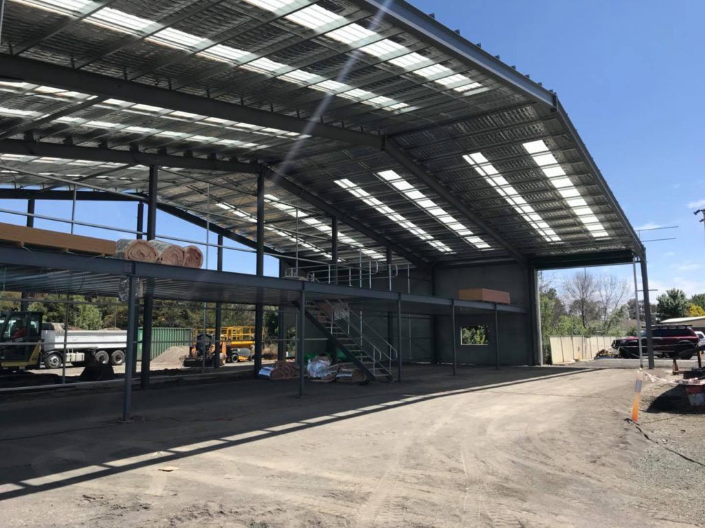 A large metal building with a roof that is being built — TMF Engineering In Benalla, VIC
