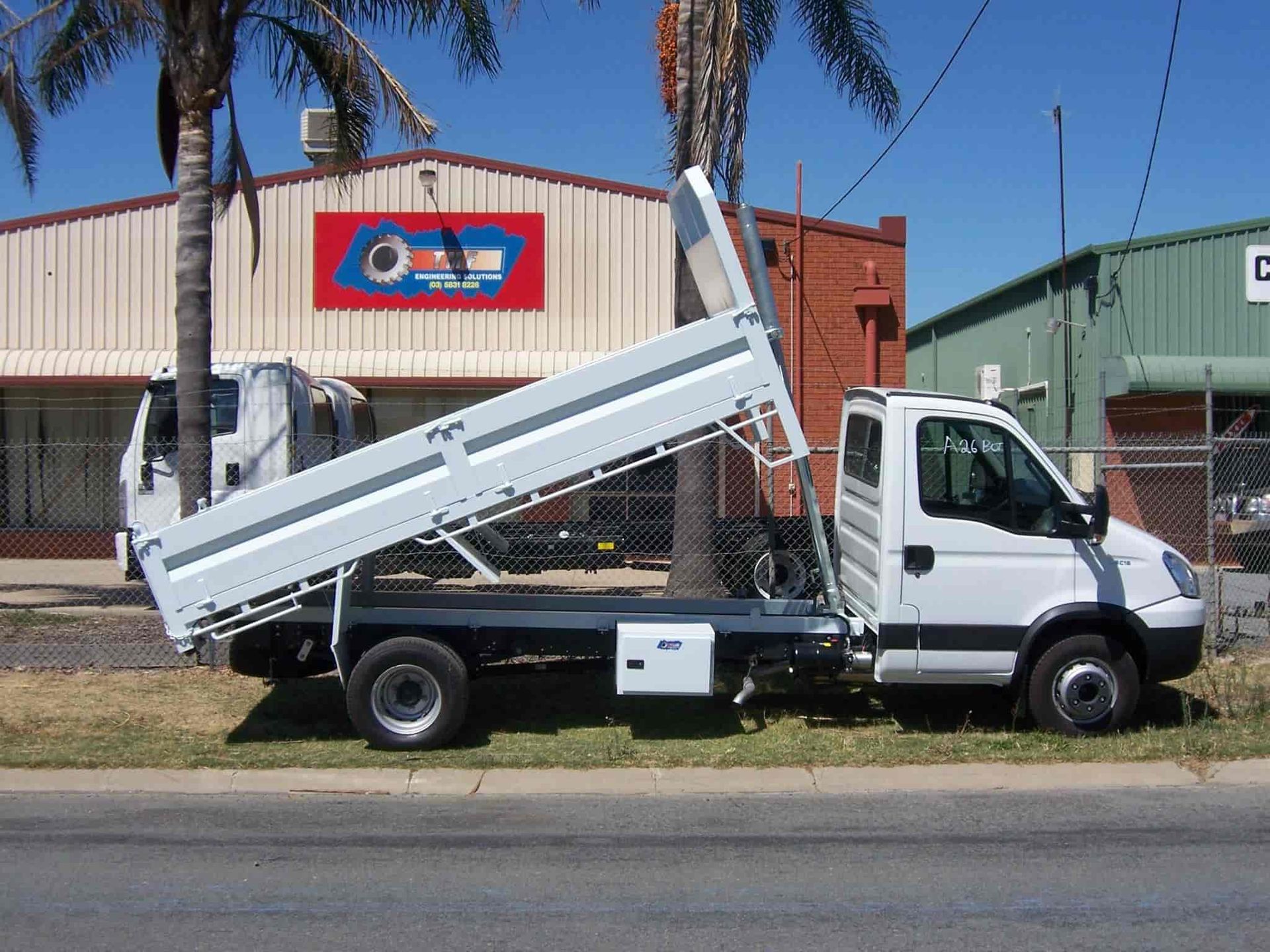 A White Dump Truck Is Parked On The Side Of The Road — TMF Engineering In Echuca, VIC