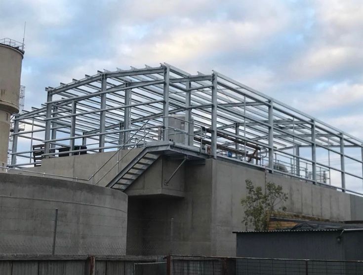 A Large Metal Structure Is Being Built On Top Of A Building — TMF Engineering In Benalla, VIC