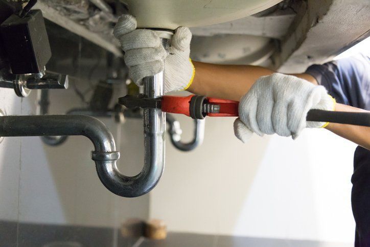 Plumber Fixing A Sink — Ellensburg, WA — Secure Plumbing and Heating Services