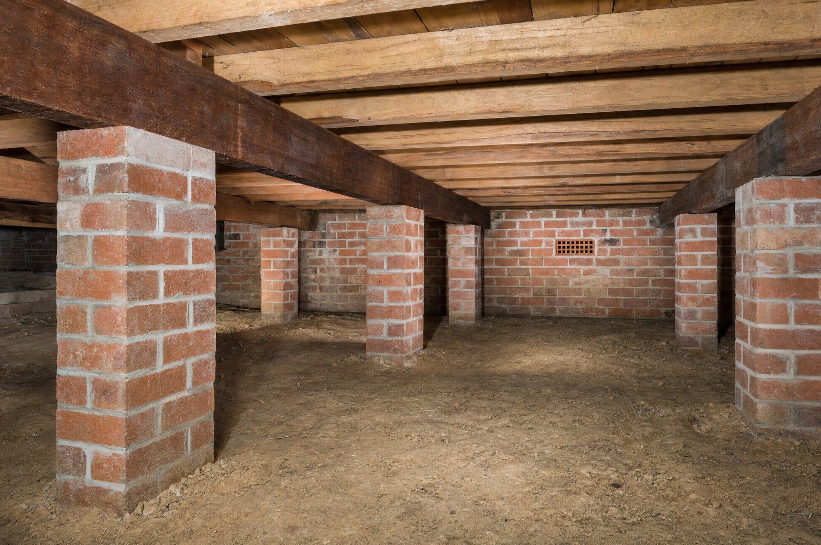 Subfloor crawl space of a Sydney brick house showing brick piers and timber bearers checked during a building and pest inspection