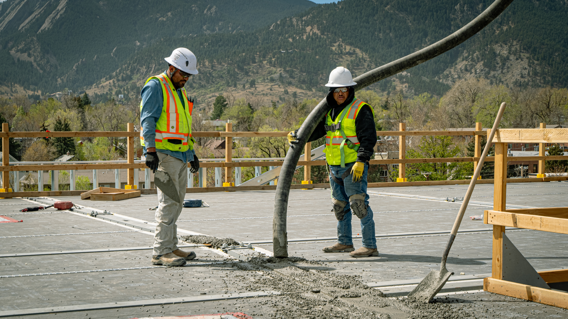 Homeowner and concrete contractor reviewing a site plan for a driveway project in Brighton CO