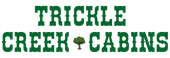 Green &ldquo;Trickle Creek Cabins&rdquo; logo with a small tree between the words