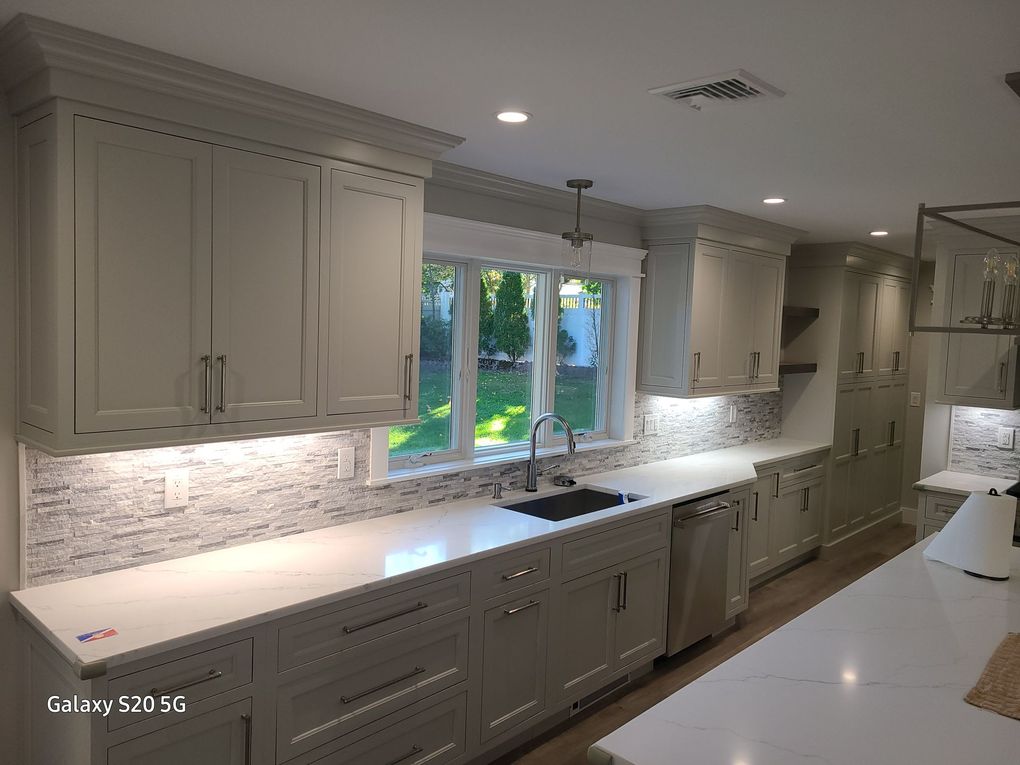 Modern kitchen with wood cabinets, stainless steel appliances, granite counters, and under-cabinet lighting. Modern kitchen with wood cabinets, stainless steel appliances, granite counters, and under-cabinet lighting.