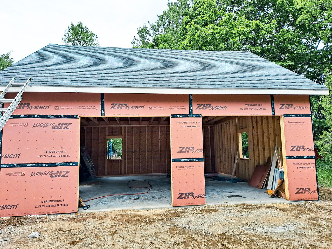 A garage is being built with a ladder in the background.