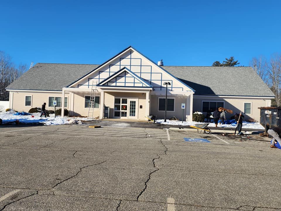 A large building with a parking lot in front of it.