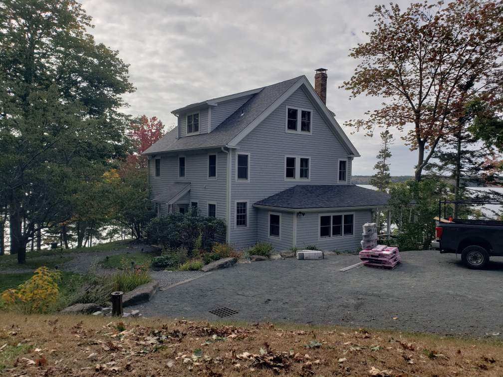 A large house with a truck parked in front of it