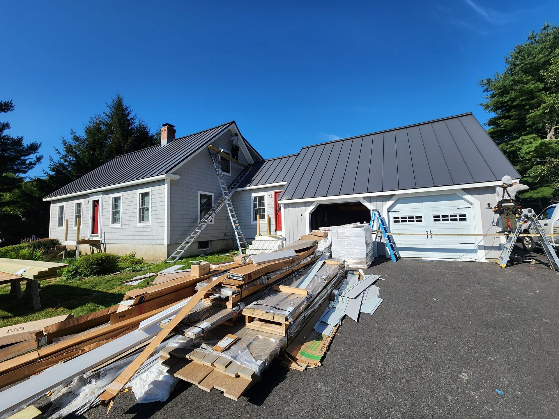 A house with a metal roof is being remodeled.