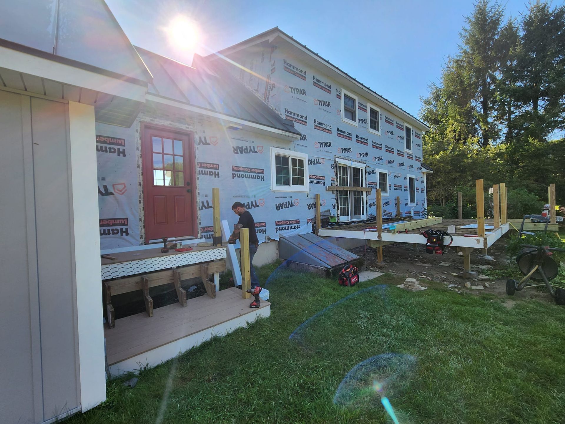 A man is working on the side of a house.