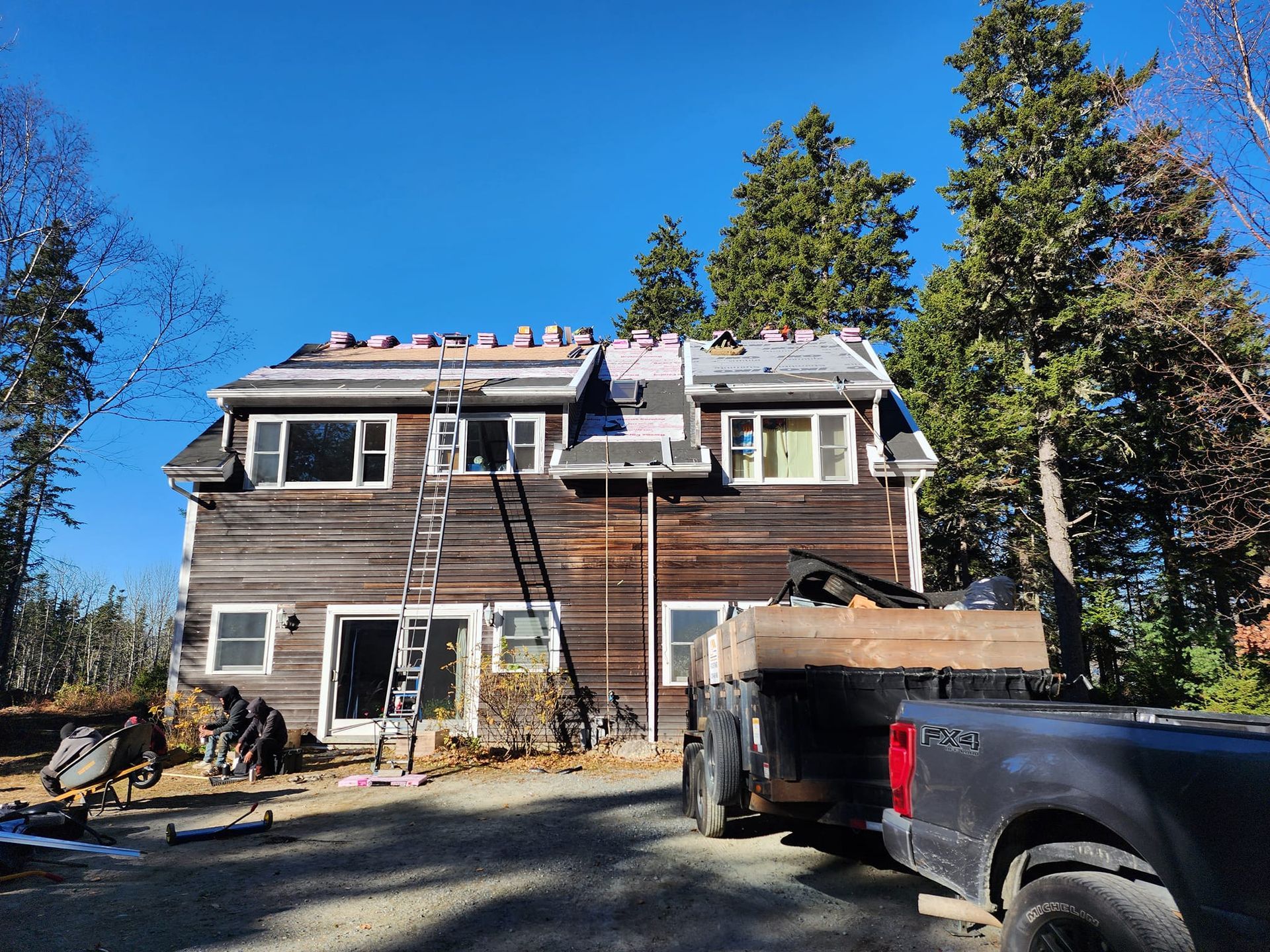 A truck is parked in front of a house that is being remodeled.