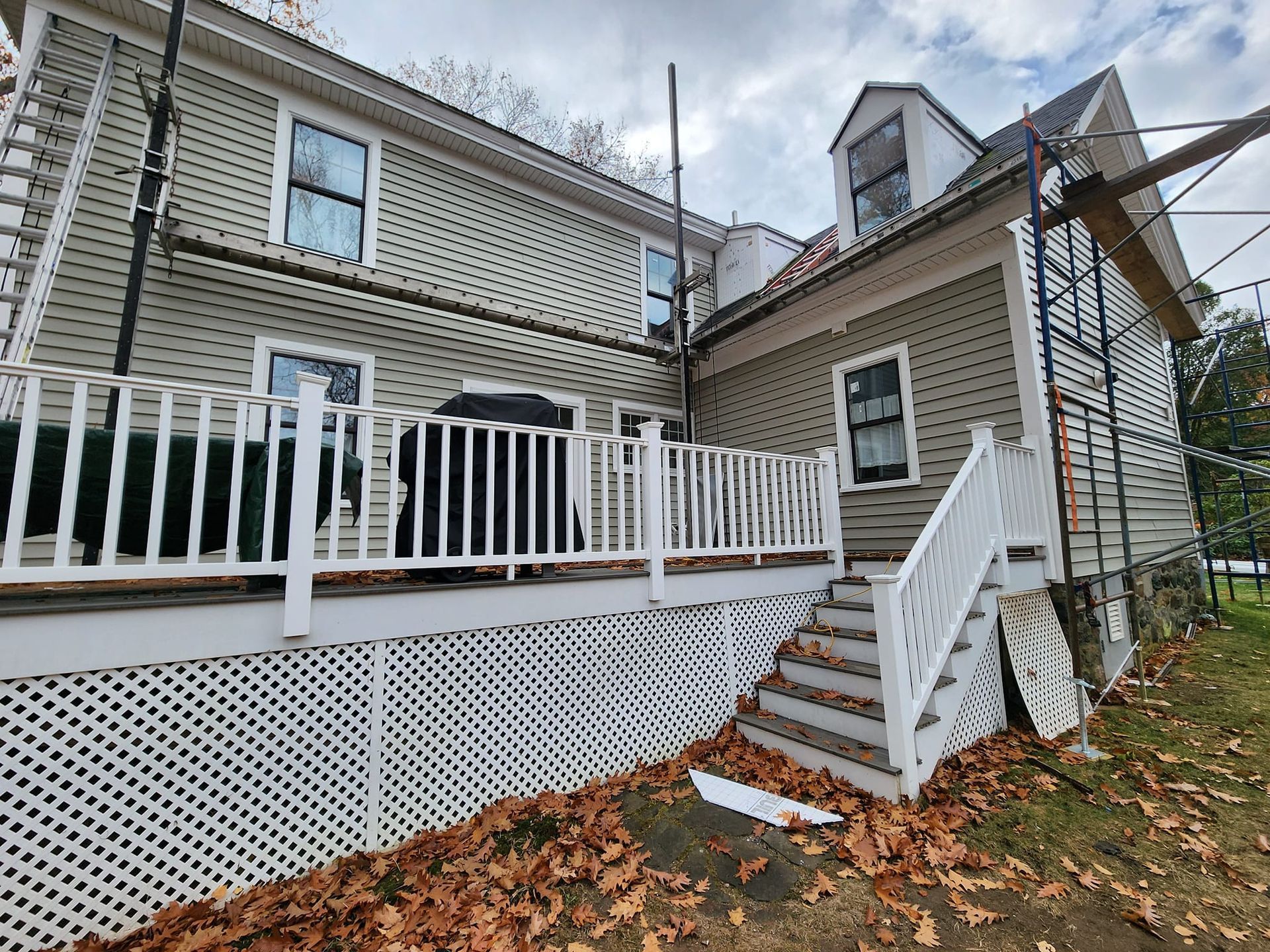 The back of a house with a deck and stairs.