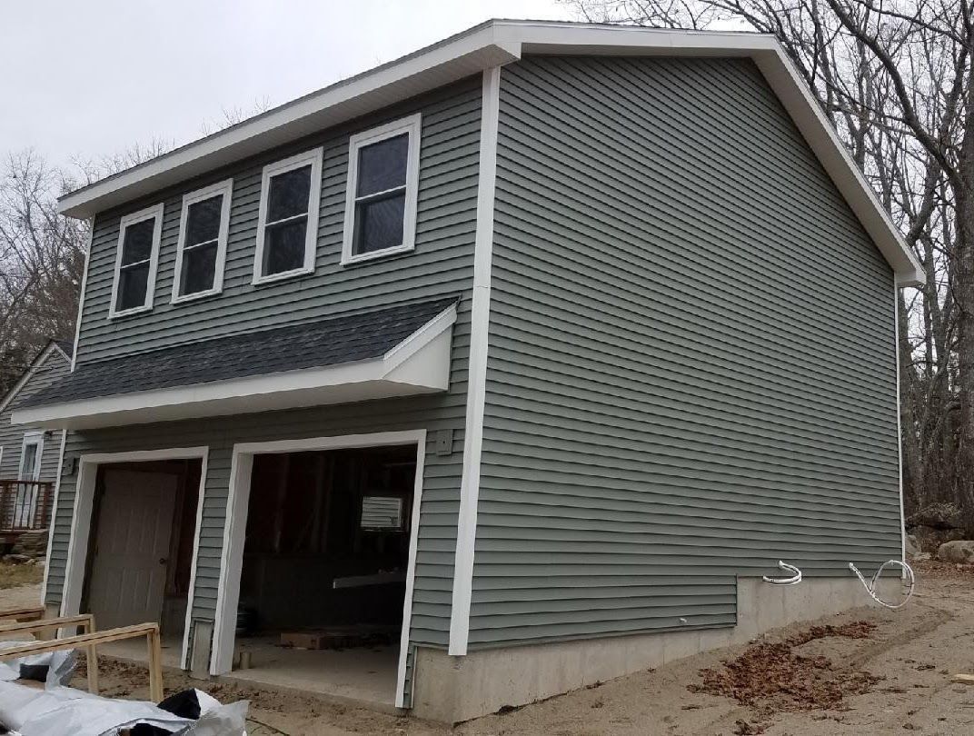 A house with a garage underneath it is being built.