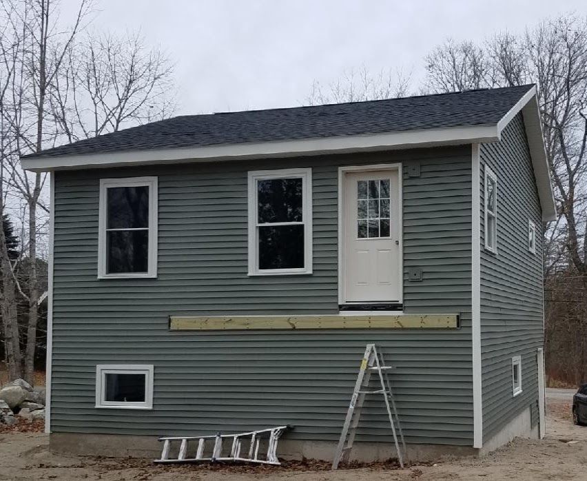 A small house with a ladder in front of it