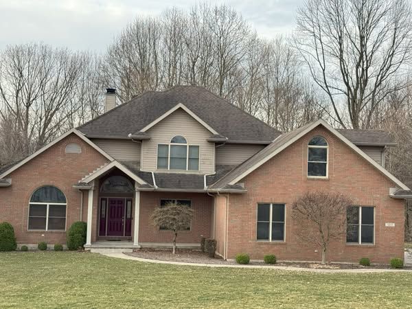 A large brick house with a gray roof