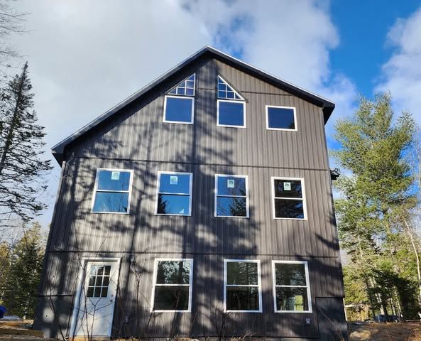 A large black house with a lot of windows