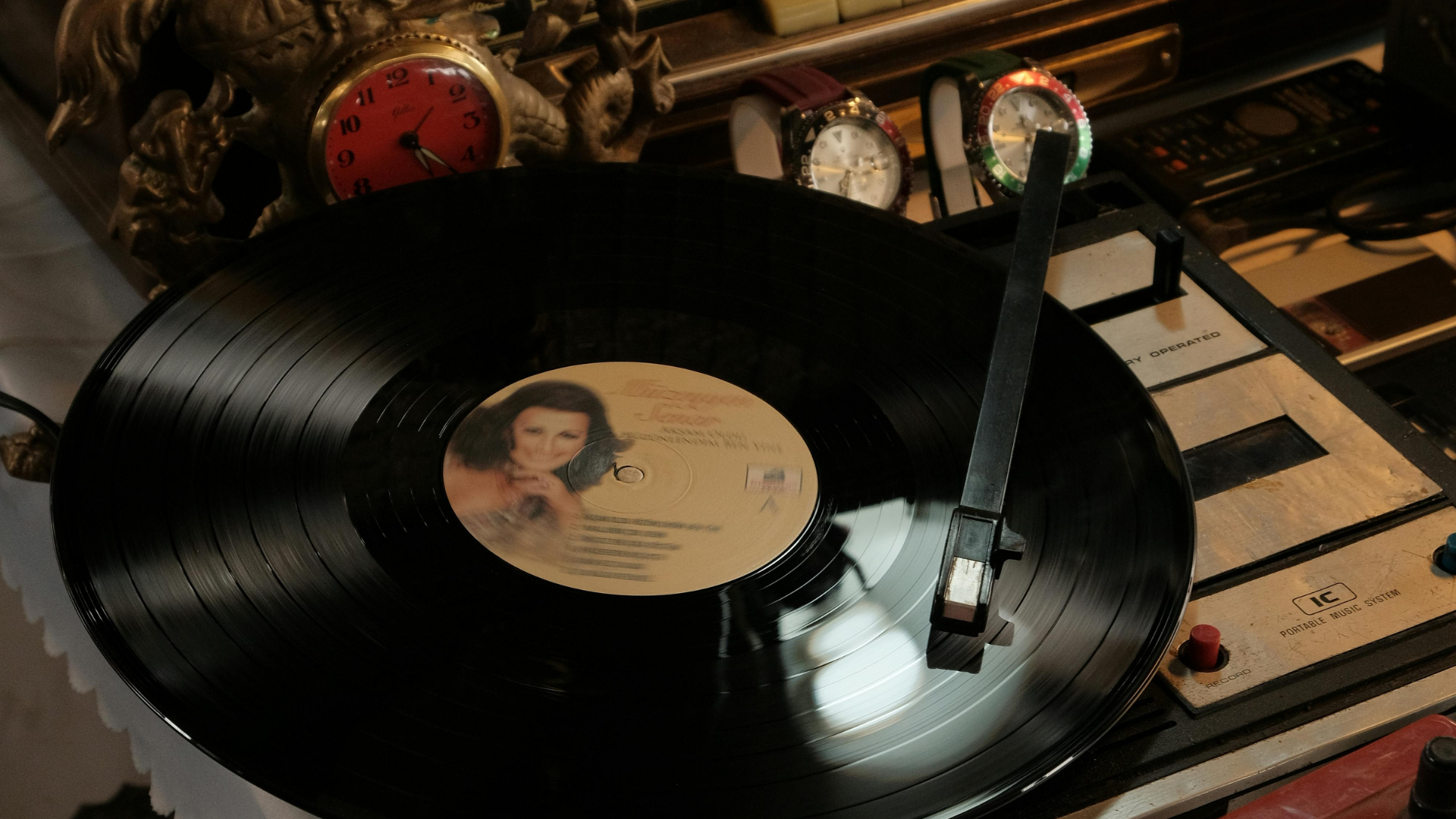 Vinyl record spinning on a turntable beside vintage audio equipment