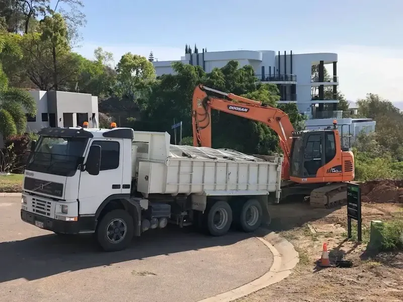 Tipper Truck Loaded with Excavator — Riley Earthmoving in Deeragun, QLD