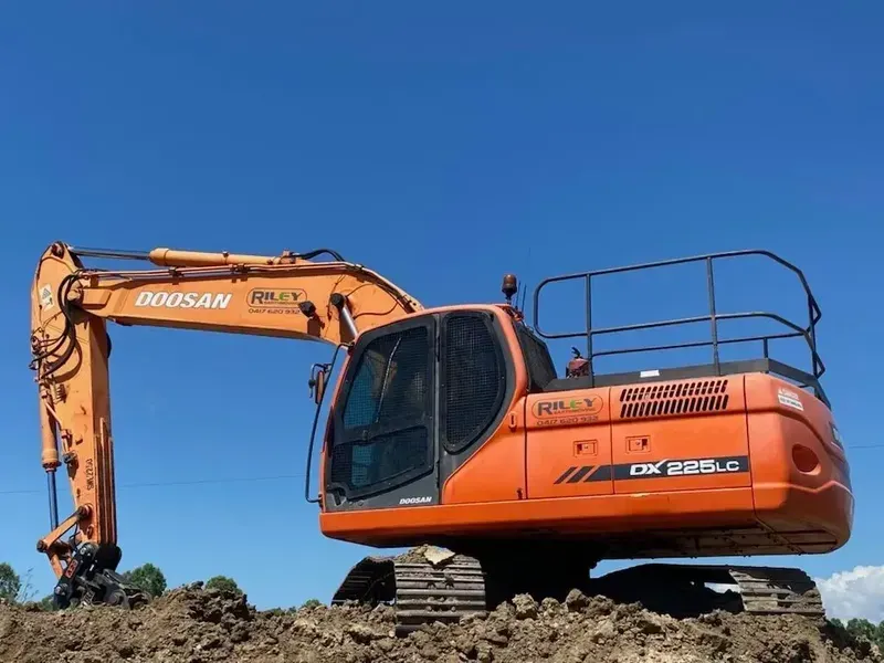 Red Mini Excavator on Trailer Truck — Riley Earthmoving in Deeragun, QLD
