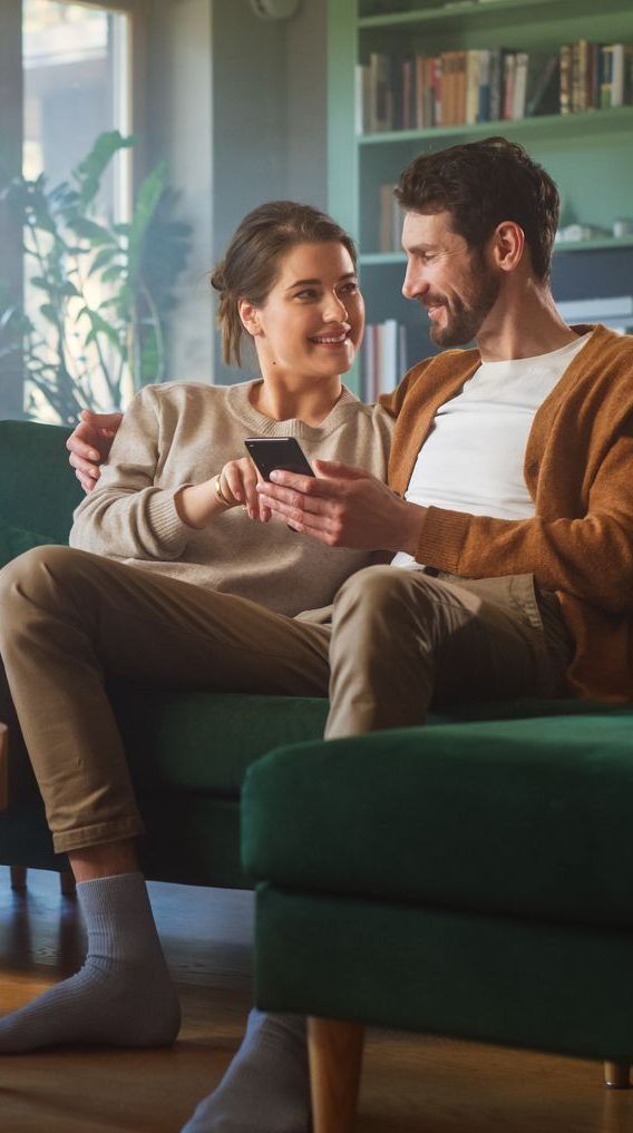 Couple using a phone together - access Online Portal