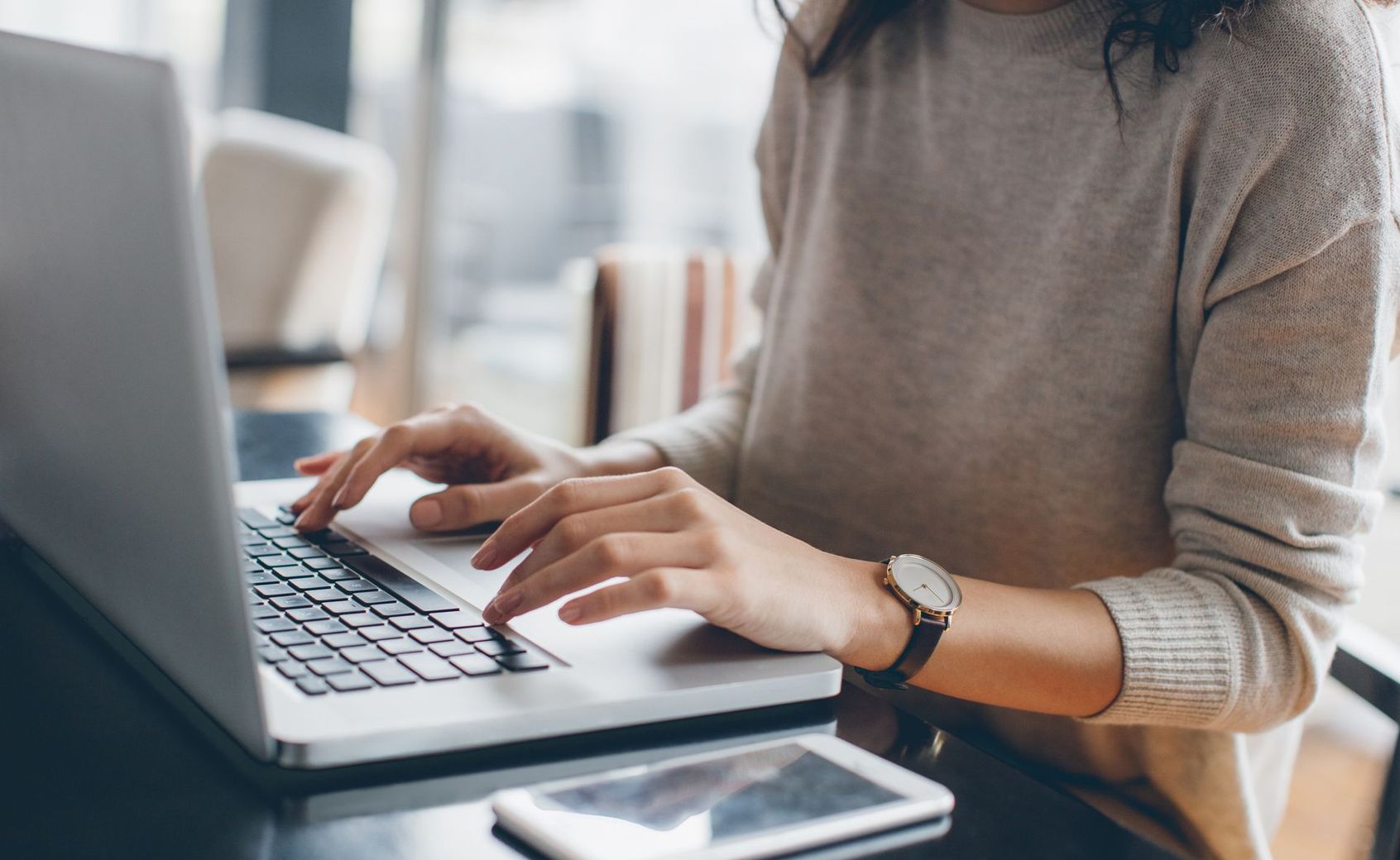 Hands using a laptop - contact us
