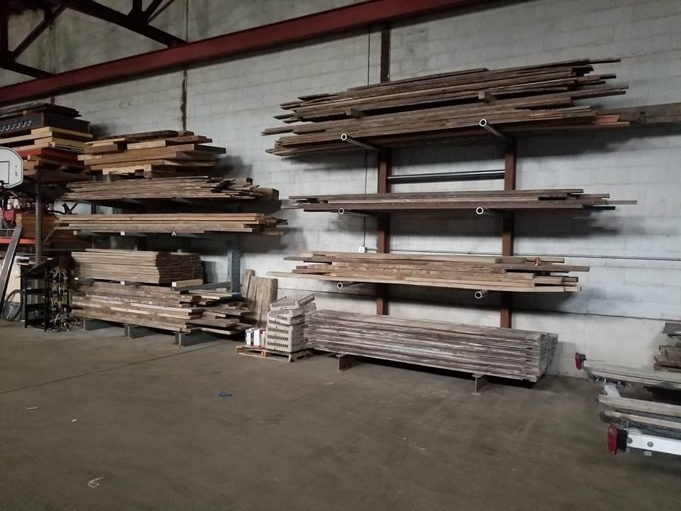 A warehouse filled with lots of wood stacked on shelves.