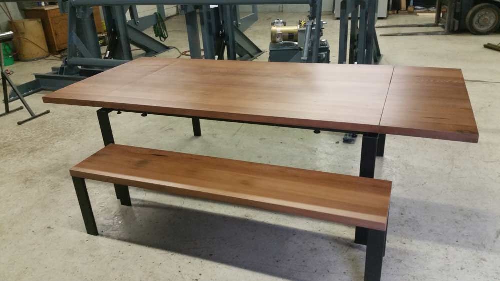 A repurposed wood table table with a bench underneath it