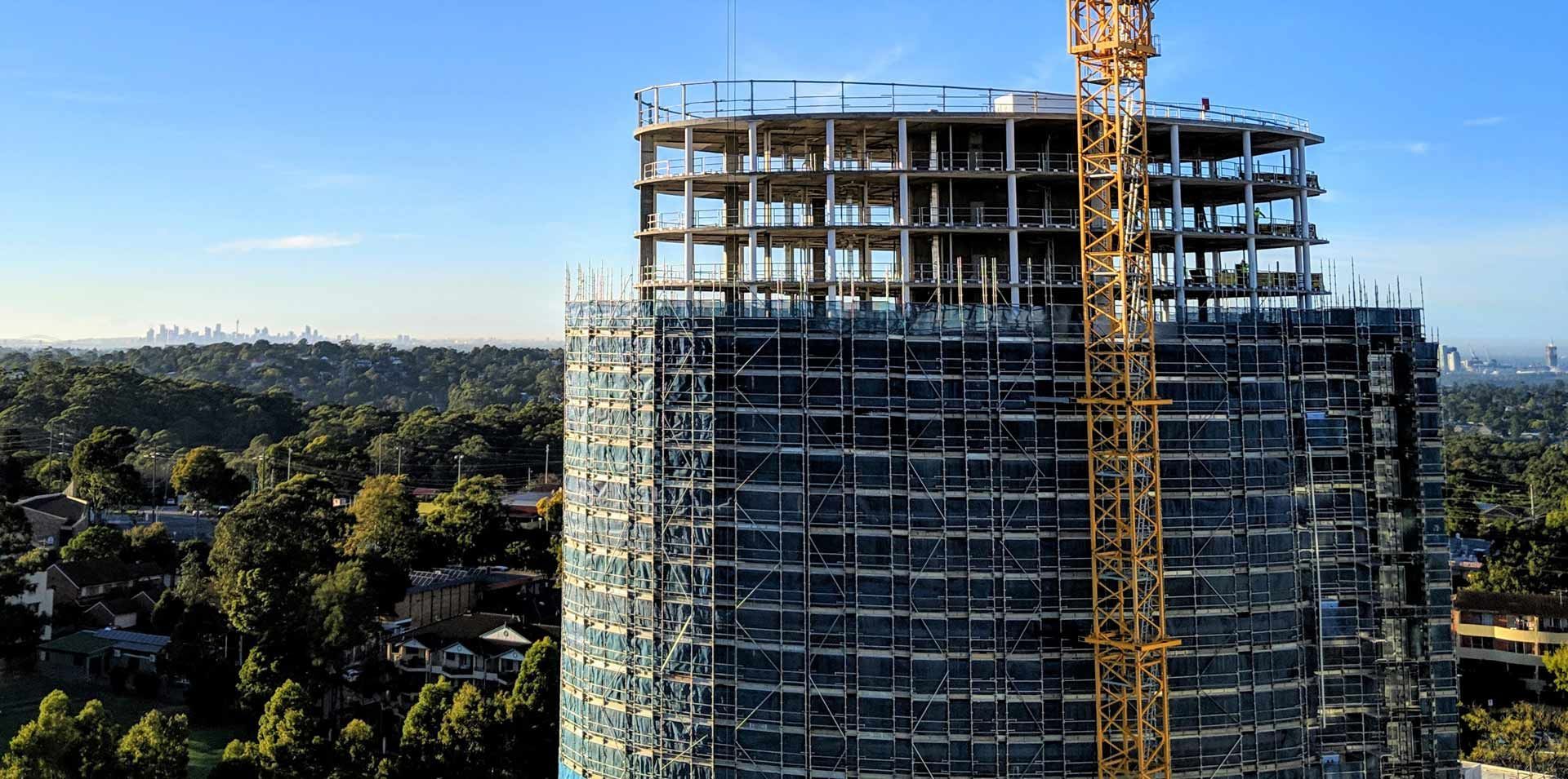 A Large Building Is Being Built With Scaffolding And A Crane – Blacktown, NSW - Sydney Hoist & Scaffolding