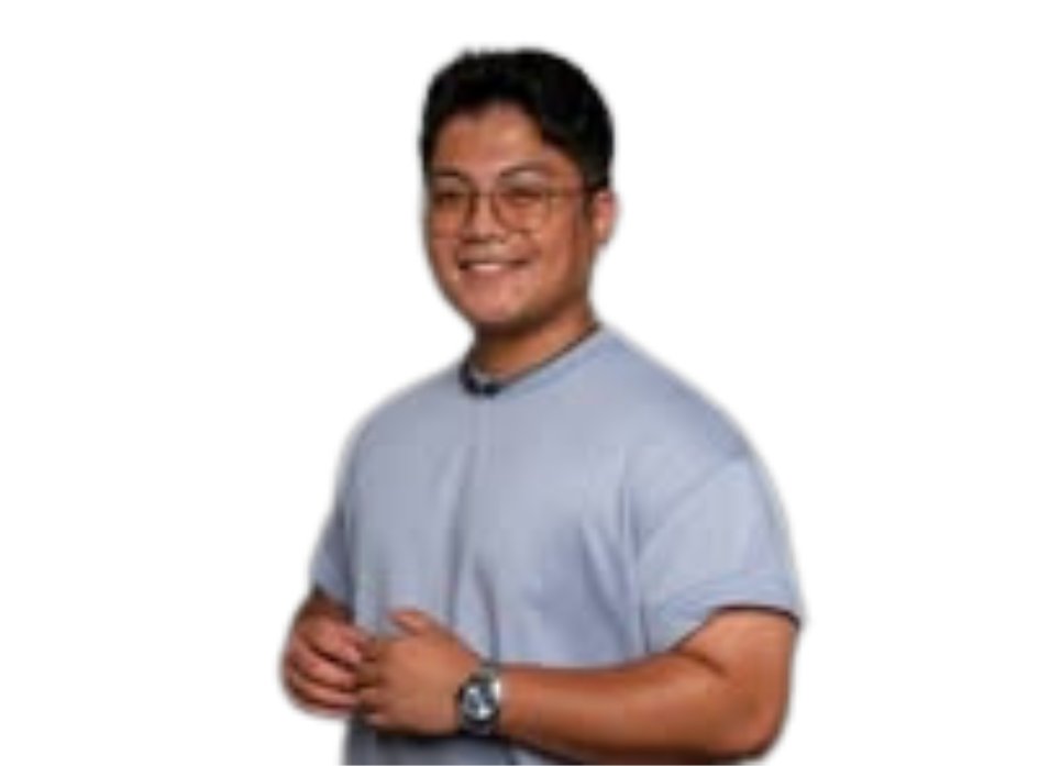 A man wearing glasses and a watch is standing in front of a white background.