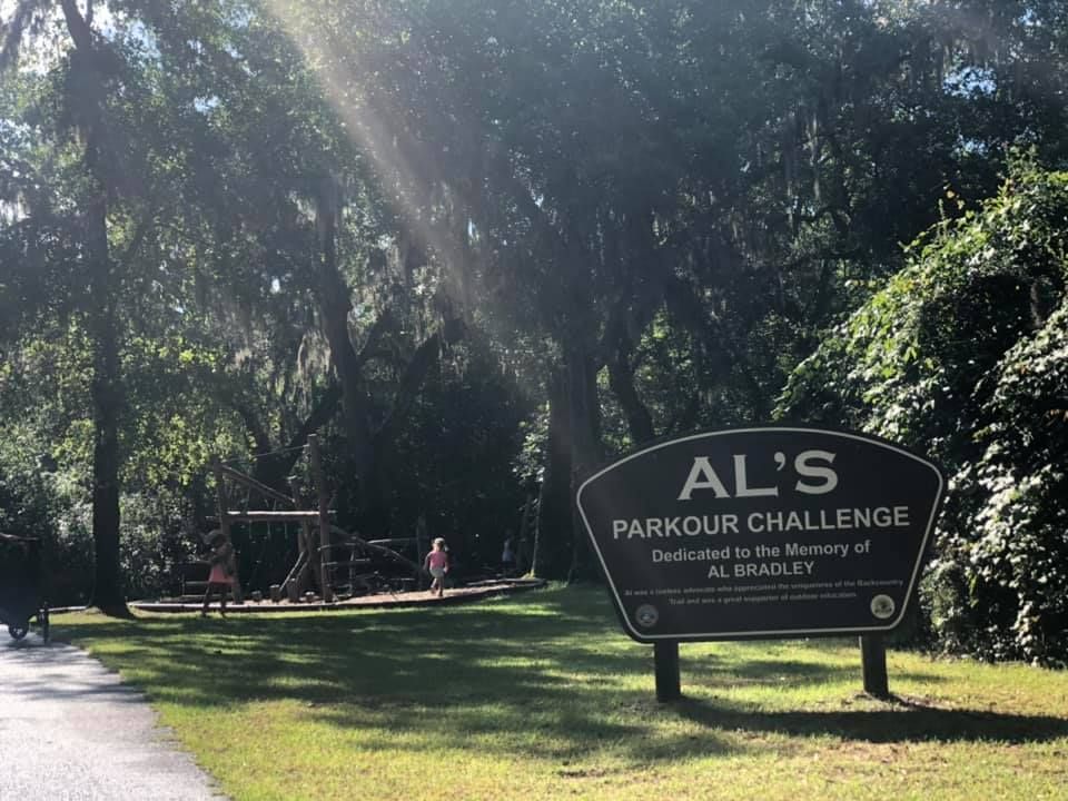 A sign for al 's parkour challenge in a park