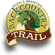 A logo for the back country trail with a tree on it