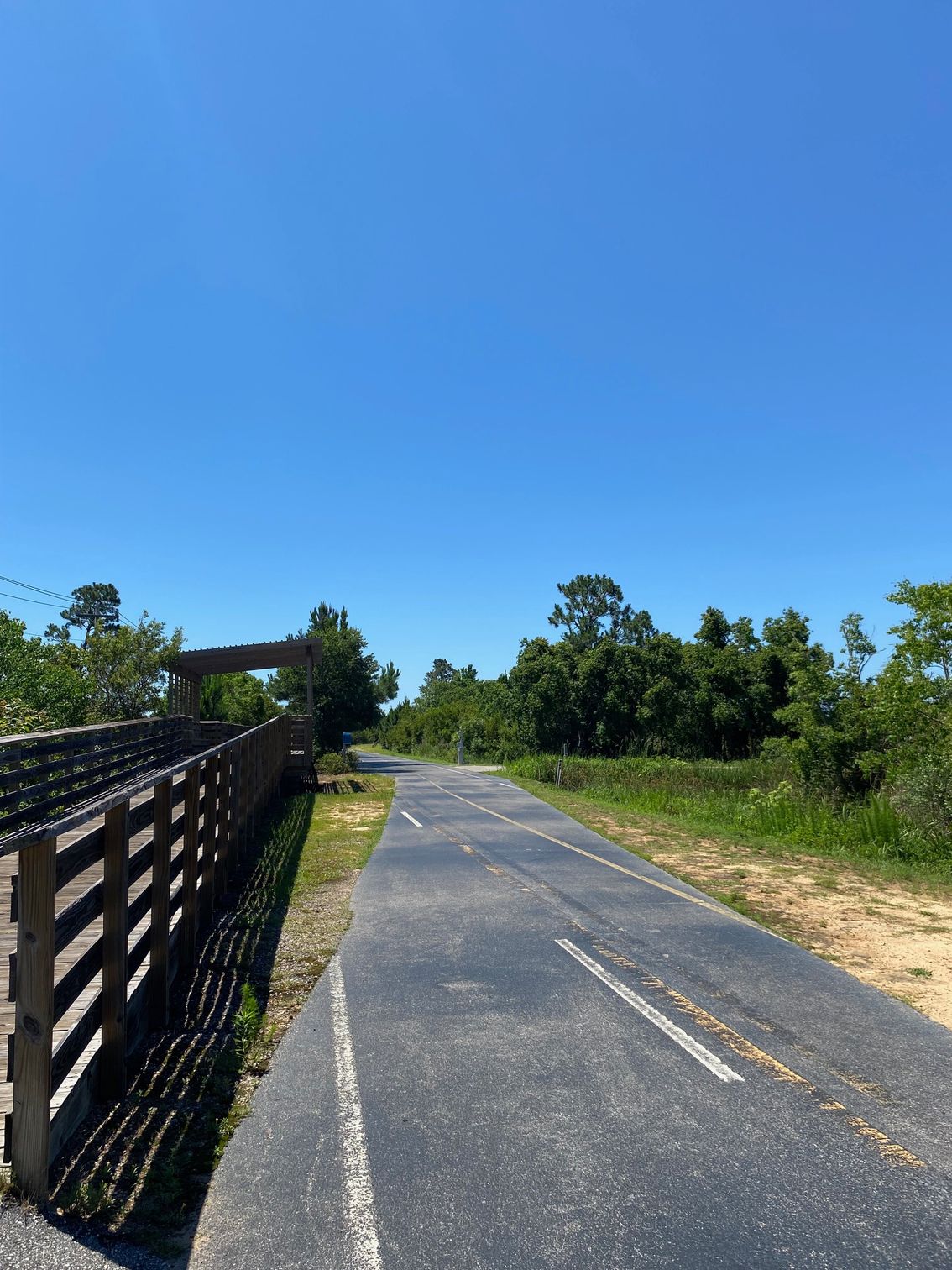 A trail with a wooden fence on the side of it