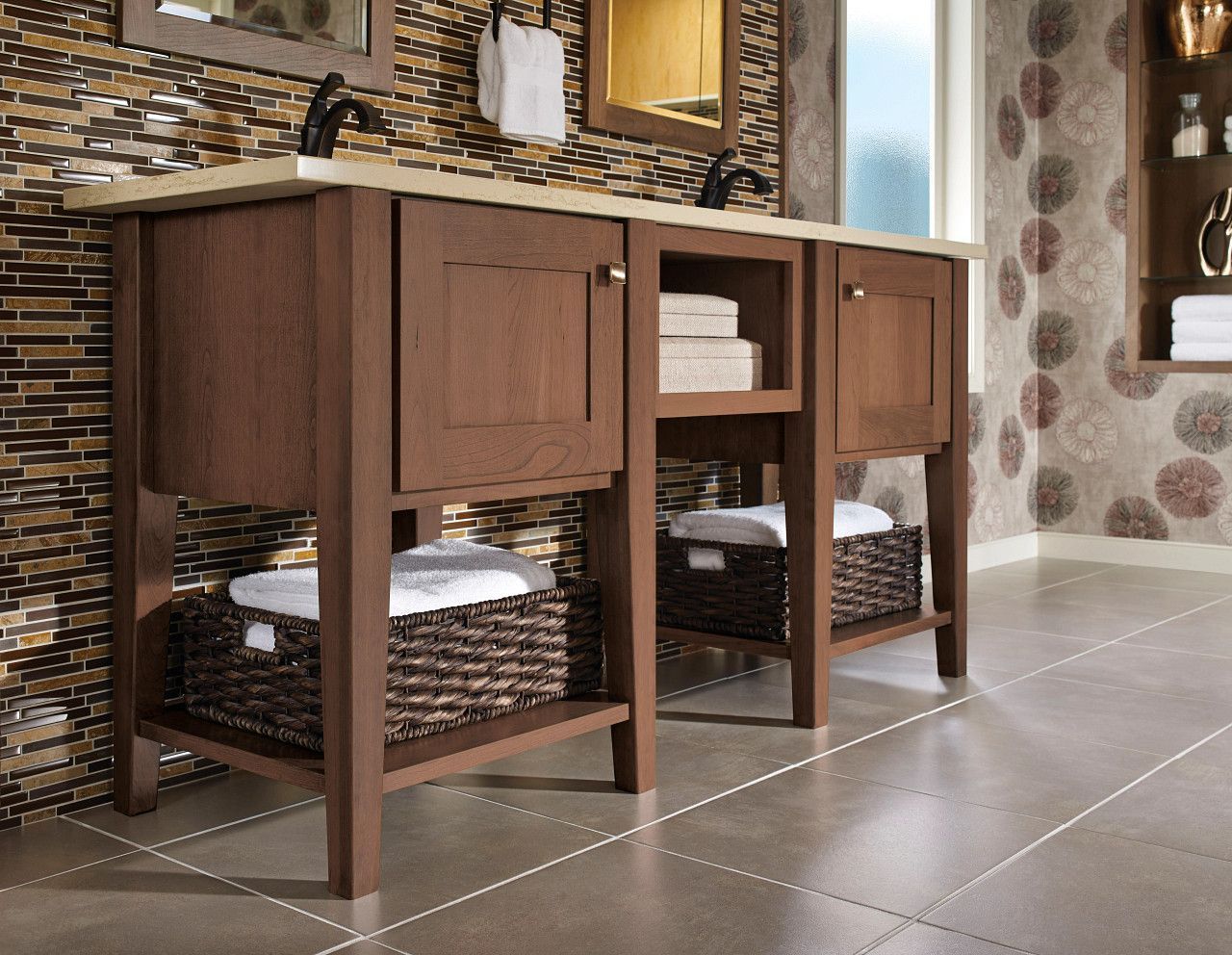 A bathroom with a walk in shower, sink, mirror and plants